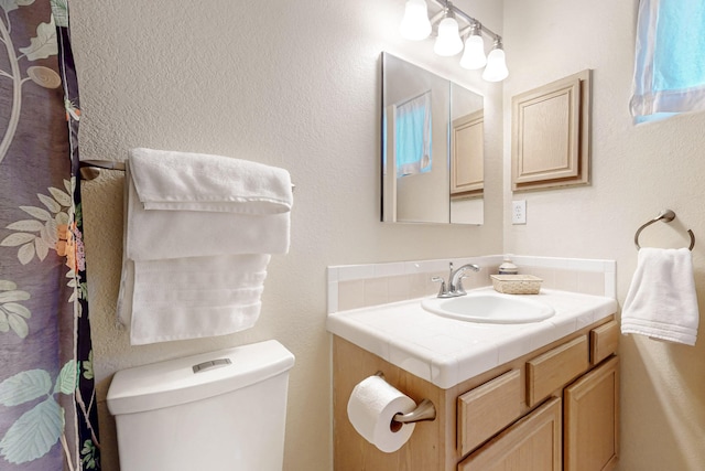 bathroom with toilet and vanity