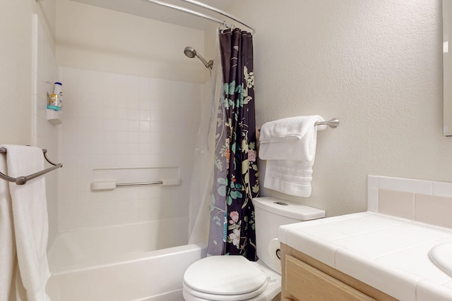 full bathroom featuring shower / bath combo, a textured wall, vanity, and toilet