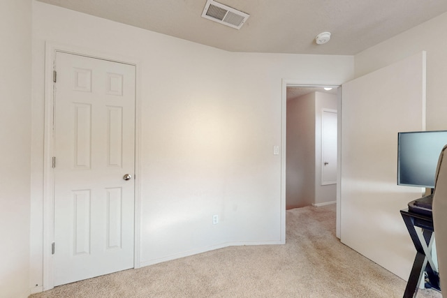 unfurnished bedroom featuring carpet, visible vents, and baseboards