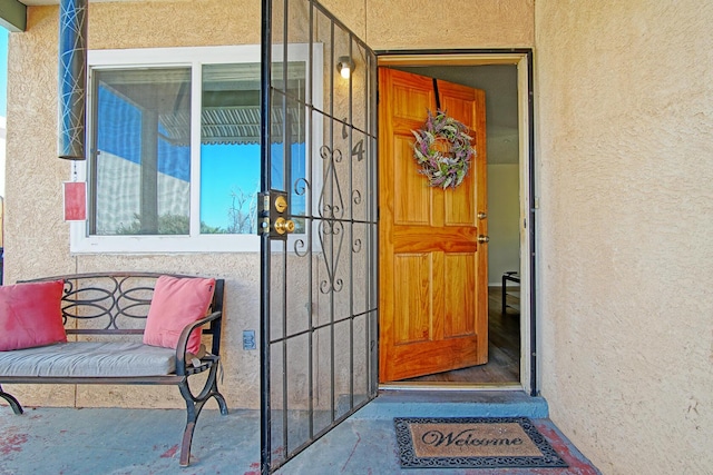 entrance to property with stucco siding