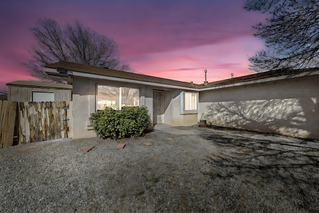 exterior space with fence and stucco siding