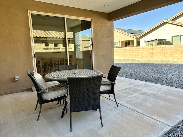 view of patio featuring outdoor dining space and fence