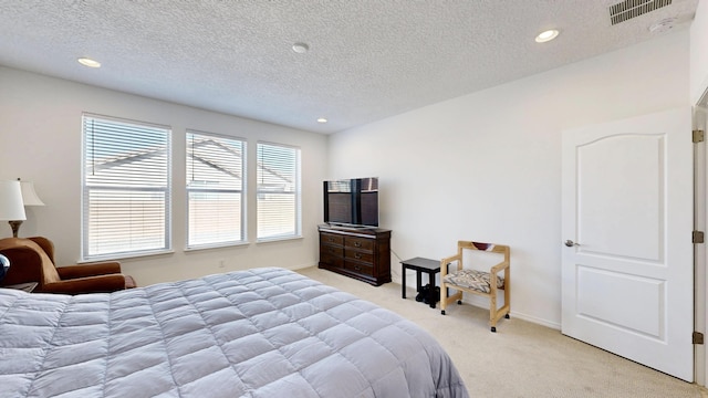 bedroom with a textured ceiling, recessed lighting, visible vents, and light colored carpet