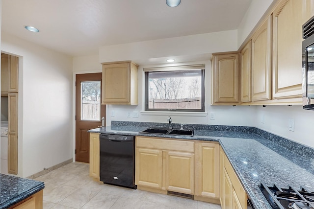 kitchen featuring a sink, visible vents, dishwasher, light brown cabinetry, and dark stone countertops