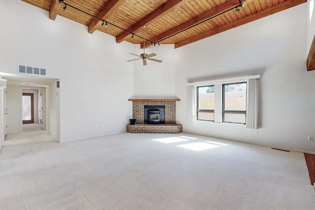 unfurnished living room featuring visible vents, wooden ceiling, beamed ceiling, carpet floors, and track lighting