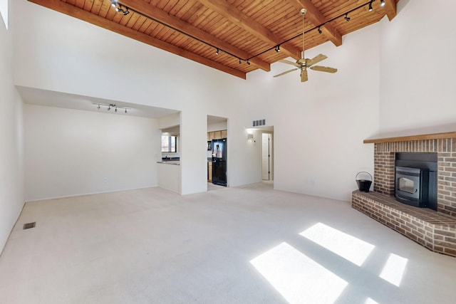 unfurnished living room featuring carpet floors, wooden ceiling, visible vents, and beam ceiling