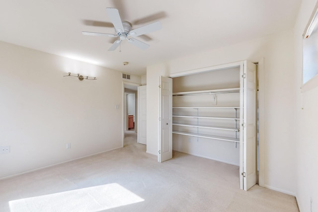 unfurnished bedroom featuring a closet, visible vents, a ceiling fan, carpet flooring, and baseboards