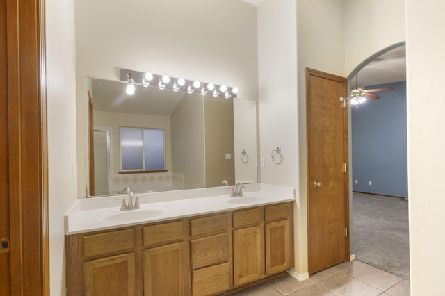 bathroom with double vanity, tile patterned flooring, a sink, and a ceiling fan