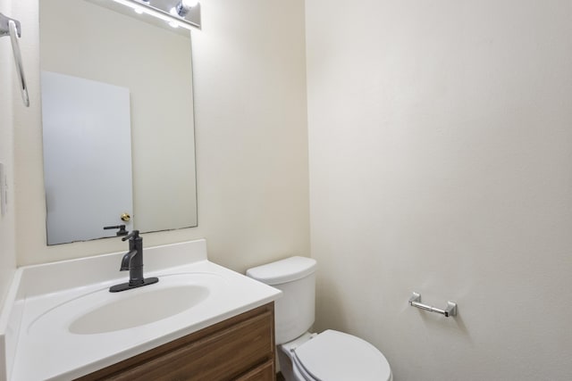 bathroom featuring toilet and vanity