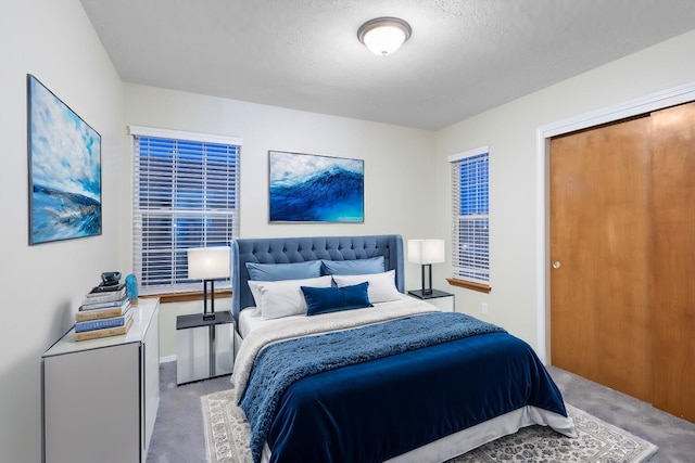 bedroom featuring carpet flooring and a textured ceiling