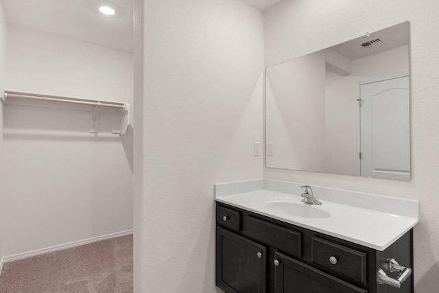 bathroom with visible vents, vanity, and baseboards