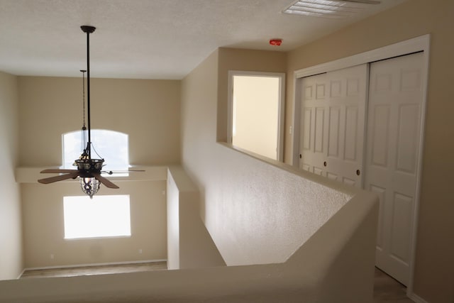 interior space featuring ceiling fan and visible vents