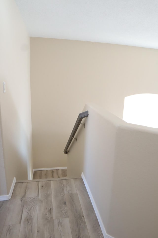 stairway featuring wood finished floors