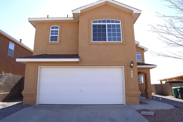 view of front facade featuring fence and stucco siding