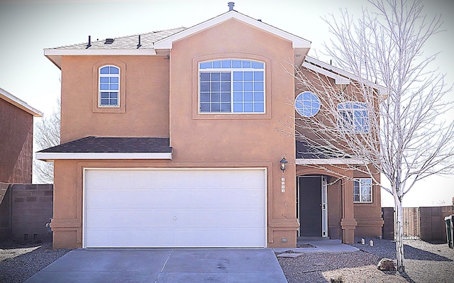 3043 Zia St NE, Rio Rancho, NM 87144 - view of front facade with fence, a garage, stucco siding, and concrete driveway