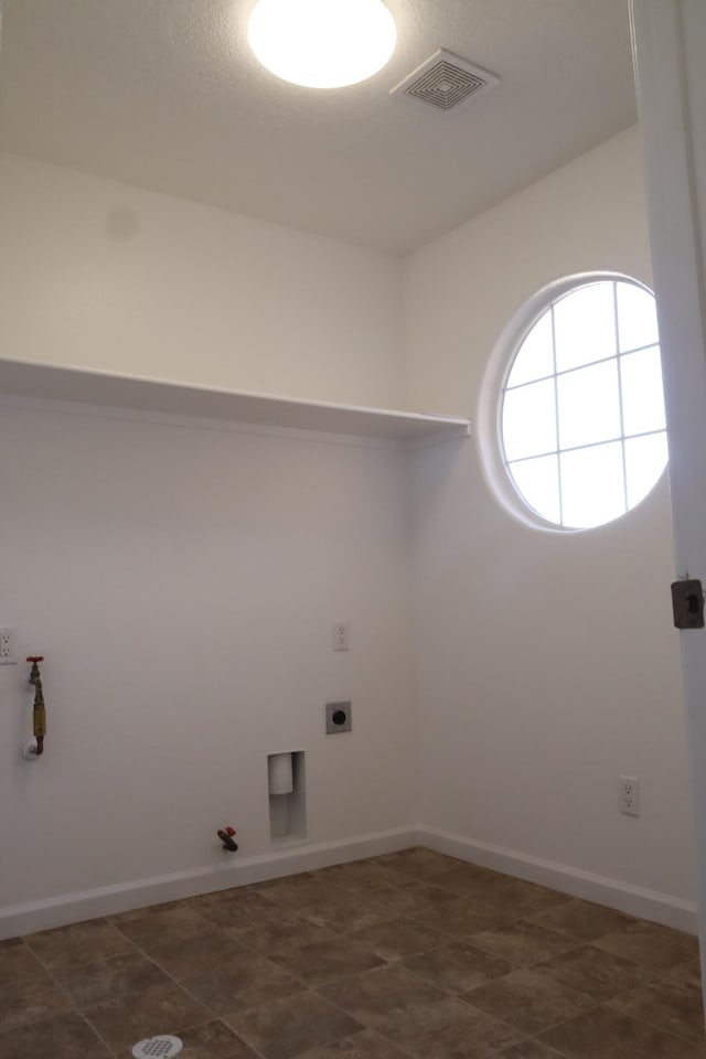 laundry area with laundry area, baseboards, visible vents, gas dryer hookup, and electric dryer hookup