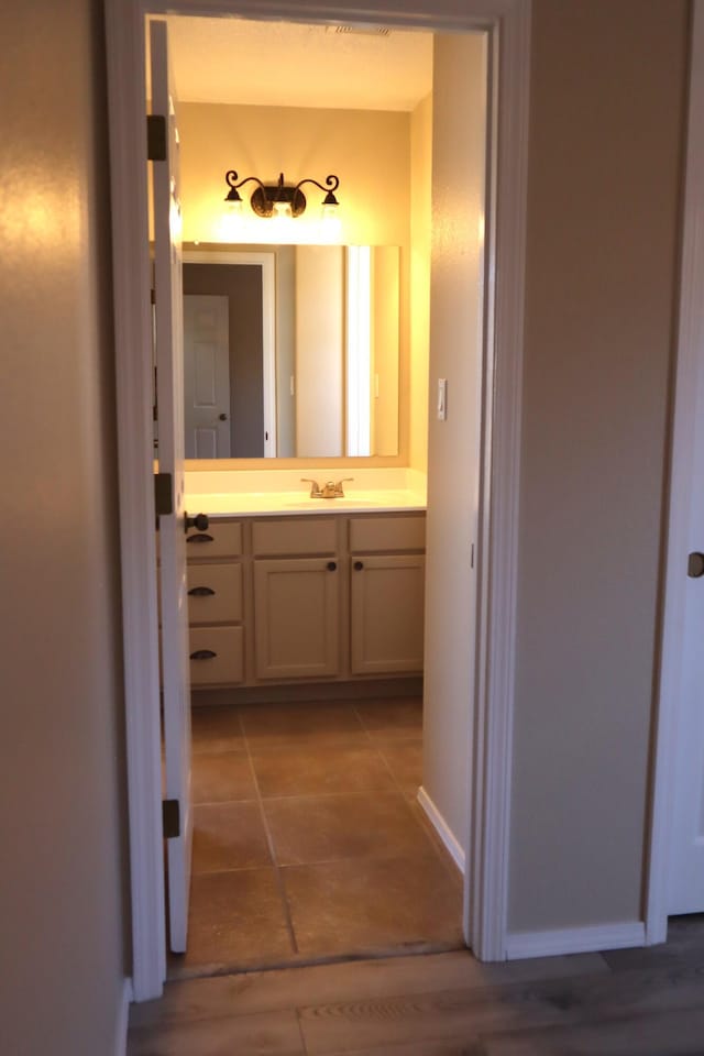 bathroom with vanity and baseboards