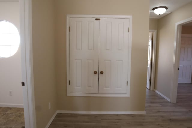 interior space with baseboards and wood finished floors