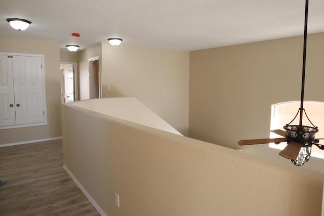 hall with dark wood finished floors and baseboards