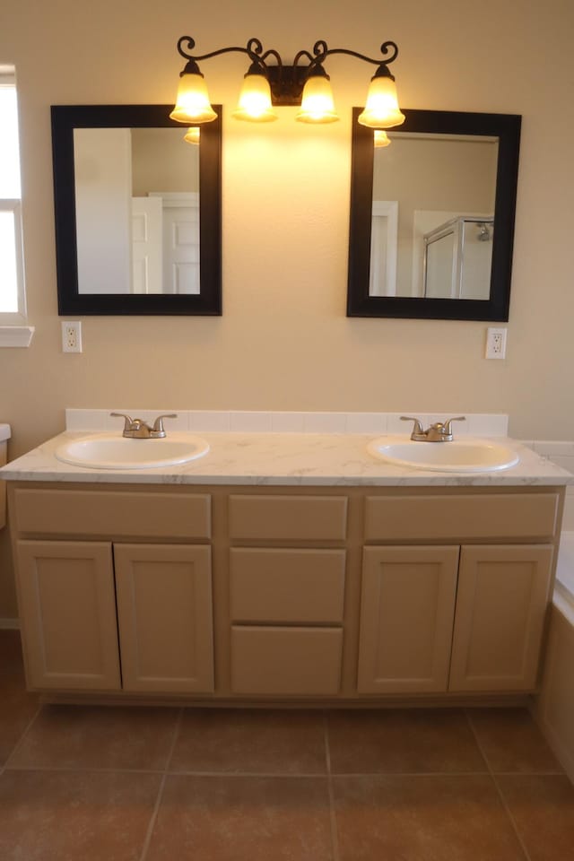 bathroom with tile patterned floors, a sink, a bath, and a shower stall