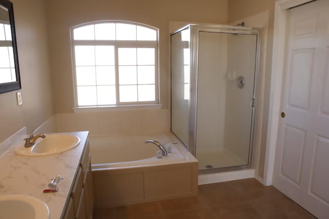 full bath featuring a stall shower, tile patterned flooring, a sink, and double vanity