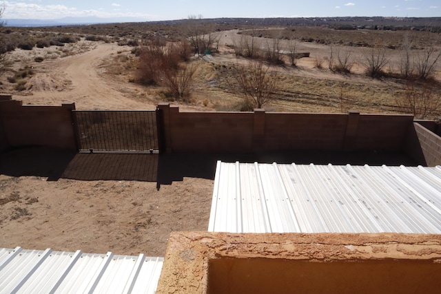 view of yard with fence and a gate