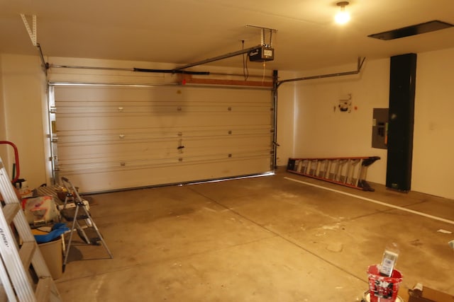 garage featuring a garage door opener and electric panel