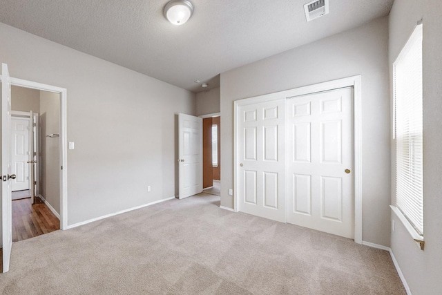 9801 Basha St NW, Albuquerque, NM 87114 - unfurnished bedroom featuring carpet floors, multiple windows, and a closet