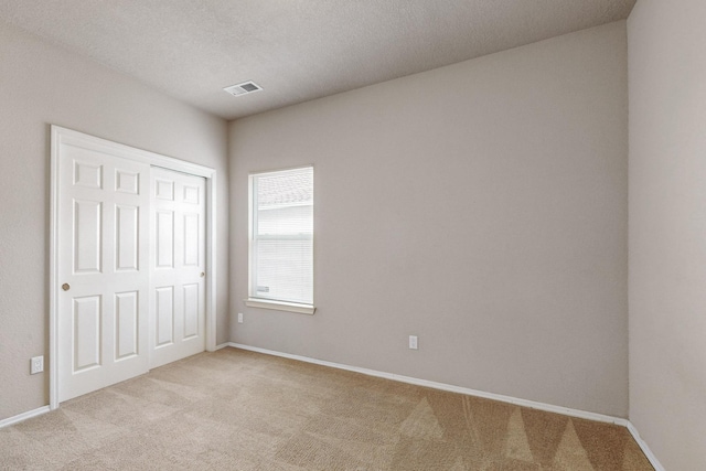 9801 Basha St NW, Albuquerque, NM 87114 - unfurnished bedroom featuring carpet flooring, a closet, and a textured ceiling
