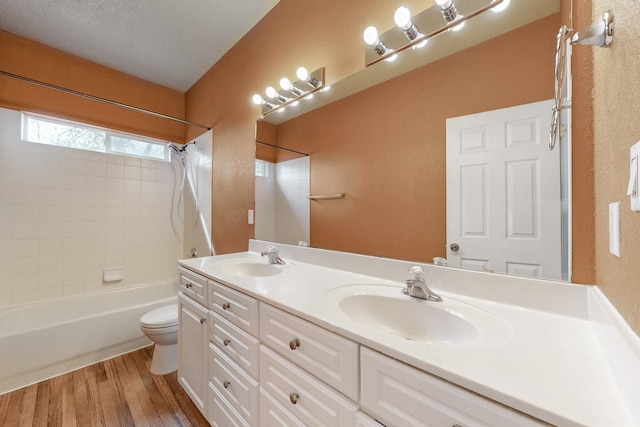 9801 Basha St NW, Albuquerque, NM 87114 - bathroom with double vanity, shower / bath combination, and wood finished floors