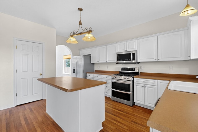 9801 Basha St NW, Albuquerque, NM 87114 - kitchen with stainless steel appliances, dark wood-type flooring, and white cabinetry