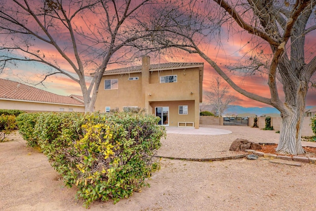 9801 Basha St NW, Albuquerque, NM 87114 - back of property with a patio, a chimney, and stucco siding