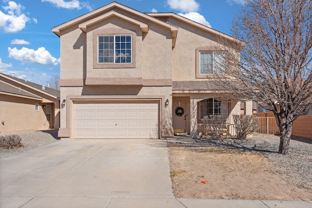 view of front of home featuring driveway, an attached garage, and stucco siding