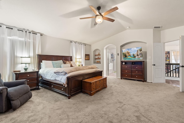 bedroom featuring light carpet, visible vents, arched walkways, a ceiling fan, and lofted ceiling