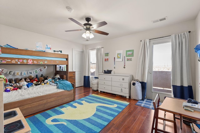 bedroom featuring dark wood-style floors, visible vents, and a ceiling fan