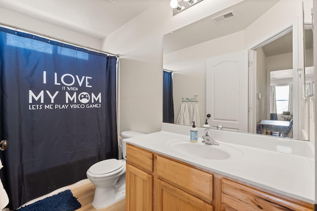 full bathroom with visible vents, toilet, a shower with curtain, wood finished floors, and vanity