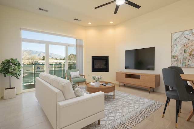 living area featuring recessed lighting, visible vents, a mountain view, and ceiling fan