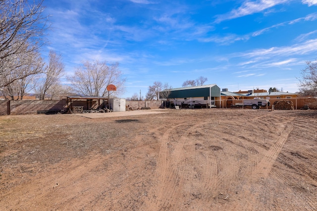 view of yard with a carport and fence