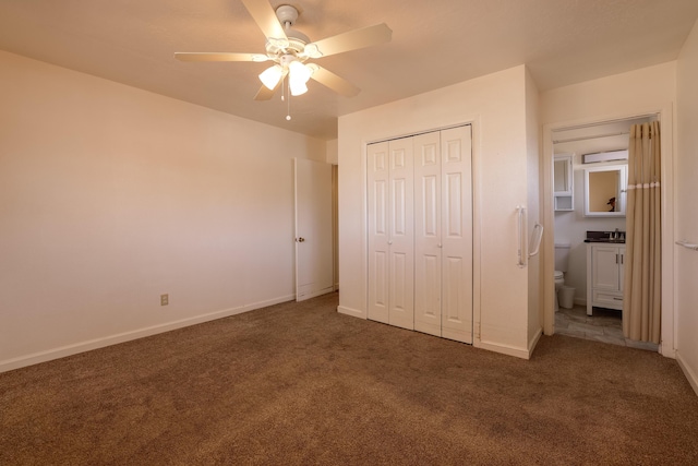 unfurnished bedroom featuring dark carpet and baseboards