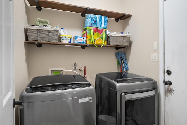 washroom featuring washer and dryer and laundry area