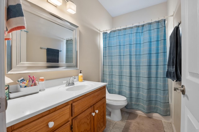 full bathroom featuring shower / bath combination with curtain, tile patterned flooring, vanity, and toilet