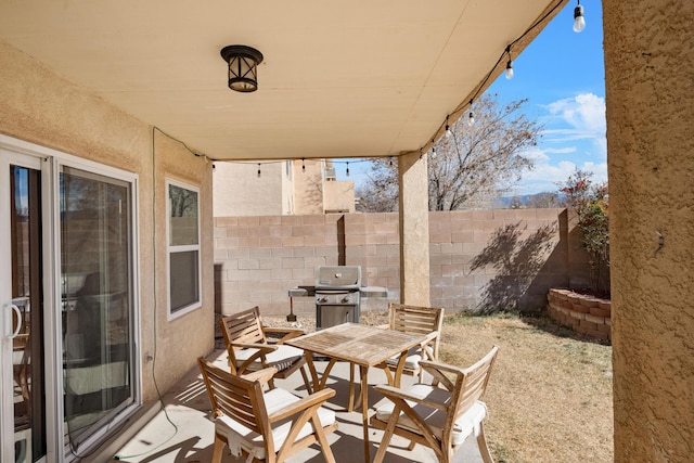 view of patio / terrace with a fenced backyard, a grill, and outdoor dining area