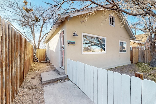 view of property exterior featuring a fenced backyard and stucco siding