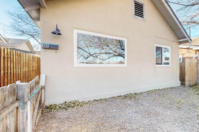 view of home's exterior featuring fence and stucco siding