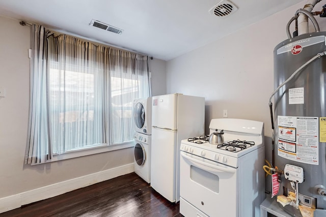 kitchen featuring white appliances, stacked washer and dryer, visible vents, dark wood finished floors, and gas water heater