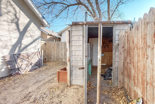 view of shed featuring fence