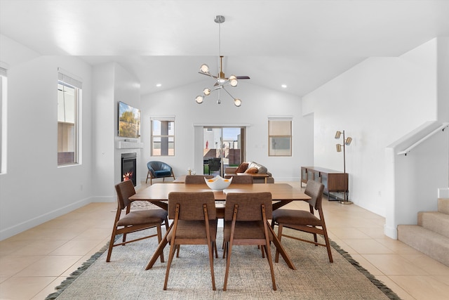 6052 Nauman Dr SE, Albuquerque, NM 87106 - dining room featuring stairs, a glass covered fireplace, lofted ceiling, and light tile patterned floors