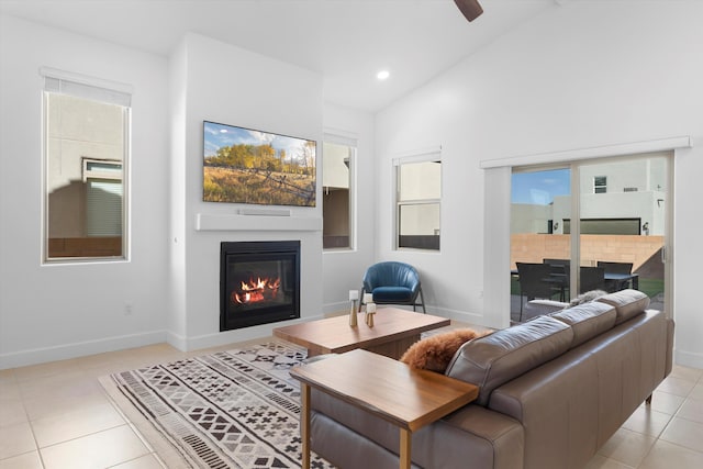 6052 Nauman Dr SE, Albuquerque, NM 87106 - living area with recessed lighting, baseboards, a glass covered fireplace, lofted ceiling, and light tile patterned flooring