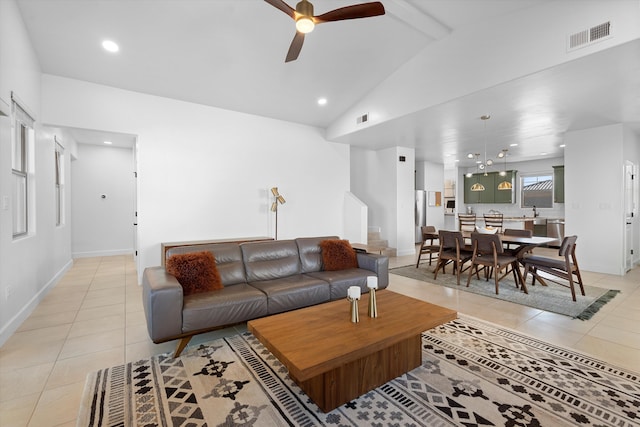 6052 Nauman Dr SE, Albuquerque, NM 87106 - living area with light tile patterned floors, lofted ceiling with beams, visible vents, and a ceiling fan
