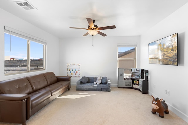 6052 Nauman Dr SE, Albuquerque, NM 87106 - carpeted living area with baseboards, visible vents, and ceiling fan